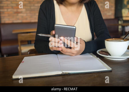 Young Asian lady using smartphone Stock Photo