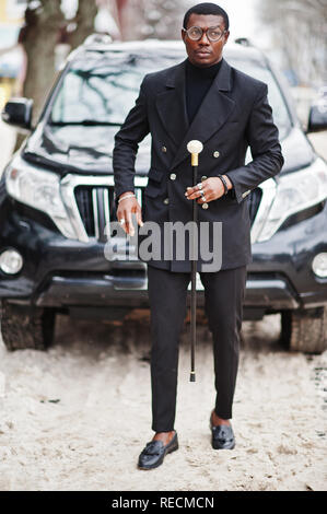 Stylish african american gentleman in elegant black jacket, holding retro  walking stick as cane flask or tippling cane with golden diamond ball  handle. Rich fashionable afro man. 10465603 Stock Photo at Vecteezy