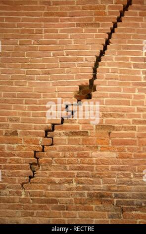 Crack in brick wall caused by earthquake Stock Photo