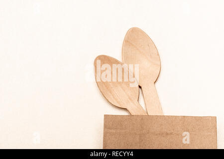 Wooden spoon Eco-friendly disposable utensils made of bamboo wood and paper Stock Photo