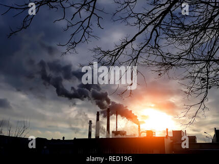 Factory chimneys with black smoke. Factory smokestacks. Air pollution. Environment pollution concept. Ecological disaster concept. Stock Photo