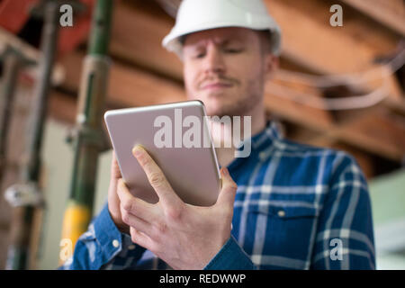 Architect Inside House Being Renovated Using Digital Tablet Stock Photo