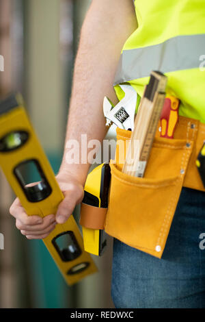 Detail Of Construction Worker On Building Site Wearing Tool Belt Stock Photo