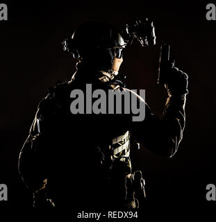 Army elite forces soldier, police special operation, counter terrorist team member in tactical ammunition with hidden behind mask identity, standing b Stock Photo