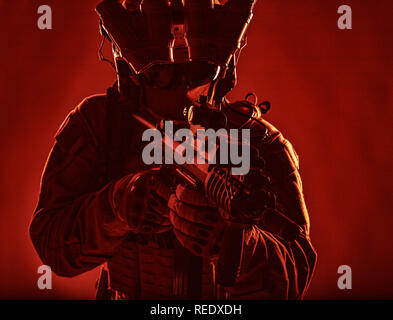Optical sight and laser device with a red beam on the M4 rifle on dark ...