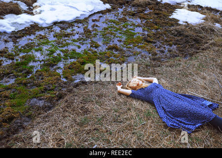 Woman laying at the marshy river Stock Photo