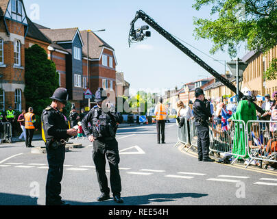 WINDSOR, UNITED KINGDOM - MAY 19, 2018: Broadcast TV camera, Constables police officers surveilling royal wedding marriage celebration of Prince Harry and Meghan Markle Stock Photo