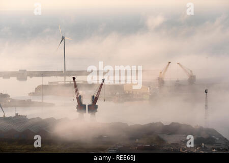 Swansea Docks Swansea Glamorgan Wales including Cranes and a Wind Turbine in the mist Stock Photo