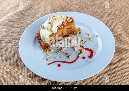 Turkish dessert ekmek kadayifi, bread pudding with cream on white Stock Photo