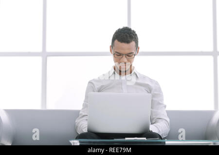 businessman works using a laptop in the hotel lobby. Stock Photo