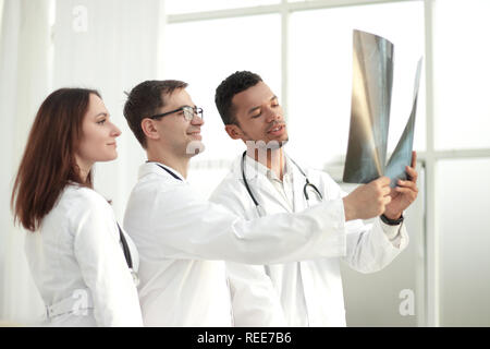 Group of doctors and nurses looking at X-ray Stock Photo