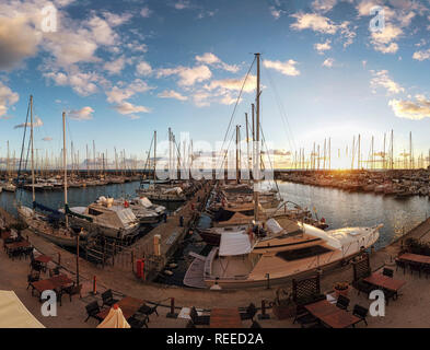 Ostia Lido Rome, Italy - January 16, 2019: Awesome sunset panorama at tourist harbor in Rome, Many sailboats are moored and the commercial premises ar Stock Photo