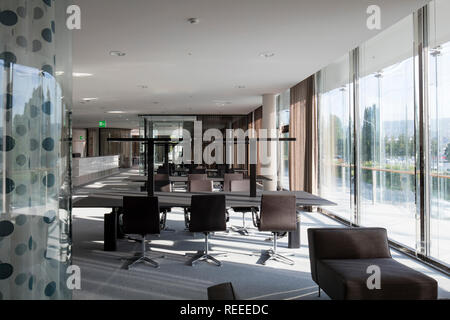 Open plan office with glazed think tanks. Swiss Re Office headquarters, Zurich, Switzerland. Architect: Diener & Diener, 2017. Stock Photo