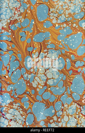 A handmade marble patterned paper in blue and brown. Stock Photo