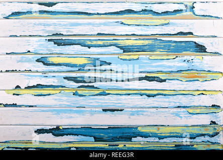 Sanded abstract paint grunge background in yellow, blue, pink and antique black on a louvered, textured wood panel Stock Photo