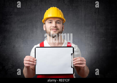 Worker showing blank clipboard Stock Photo
