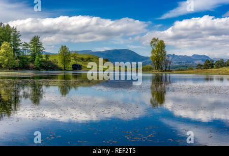 Reflection in Wise Een Tarn on Colthouse Heights near Far Sawrey in Cumbria Stock Photo