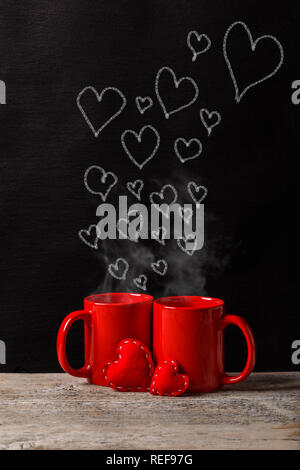 Two red cups with chalk-drawn on the blackboard Stock Photo