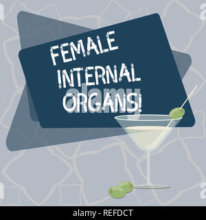 Writing note showing Female Internal Organs. Business photo showcasing The internal genital structures of the Filled Cocktail Wine Glass with Olive on Stock Photo