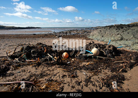 Beach pollution plastics tyres and ropes washed up on a beach in Elie Fife Scotland Stock Photo