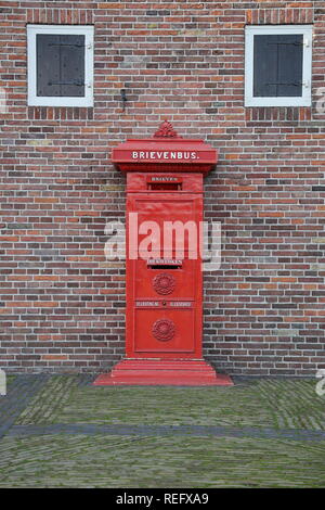 Historic red postbox in Zaanse Schans, Netherlands. Stock Photo