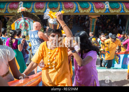 Kuala Lumpur, Malaysia.. 20th Jan, 2019. Elderly Hindu devotee carries pot of milk on her heads on, trying to complete her pilgrimage to the sacred Batu Caves temple during the Thaipusam festival. Thaipusam is a key Hindu ceremony that is held each year during the full moon in the tenth month of the Hindu calendar. During Thaipusam festival in South East Asia, Hindu Devotees preparing prayer blessing ceremony by piercing body hooks ‘kavadi' or milk pots on a four kilometre walk towards Batu Caves temple. Credit: YWLoh/Alamy Live News Credit: YWLoh/Alamy Live News Stock Photo