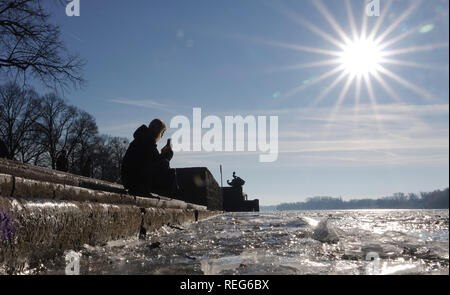 Hannover, Germany. 21st Jan, 2019. A woman photographs ice on the Maschsee. The authorities and the DLRG in Lower Saxony warn against entering the lakes in the state. An ice layer has formed in many places, but it does not yet carry humans. Credit: Sonja Wurtscheid/dpa/Alamy Live News Stock Photo