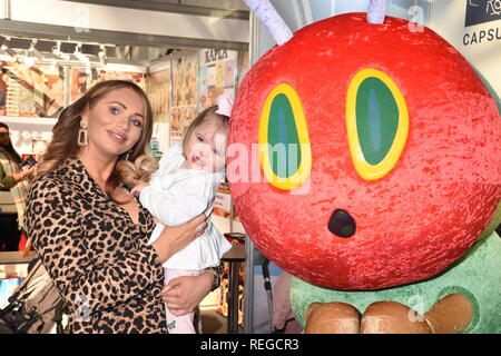22nd January, 2019. Amy Childs and daughter Polly poses with the Hungry Caterpillar, Roma Pram Stand, The Toy Fair, Olympia, London. UK  Credit: michael melia/Alamy Live News Stock Photo
