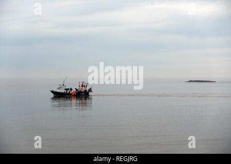 Fishing boat entering the river Ore from the North Sea, Shingle Street, Suffolk, UK. Stock Photo