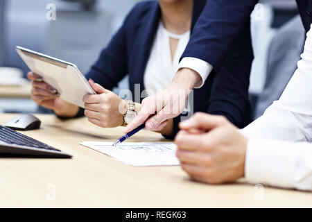 Group of business people sharing ideas in modern office Stock Photo