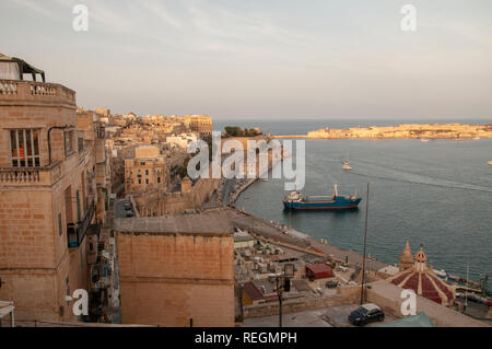 Late afternoon view over south east waterfront of Valletta town from Upper Barrakka Gardens. Stock Photo