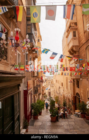 View down the steps of St. Lucia Street in Valletta, Malta with St. Lucia church at the end of it. Stock Photo