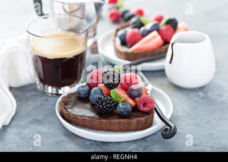 Chocolate heart tarts with ganashe filling and fresh berries Stock Photo