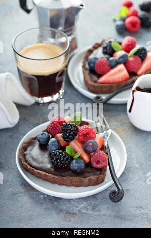 Chocolate heart tarts with ganashe filling and fresh berries Stock Photo