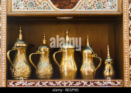Eastern pitchers stand on a shelf in an Arab shop