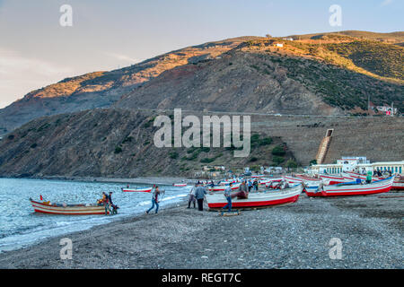 Oued Laou, Chefchaouen, Morocco - November 3, 2018: Fishermen prepare their small boats to go fishing. Oued Laou beach, a small fishing village. Stock Photo