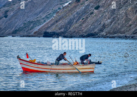 Oued Laou, Chefchaouen, Morocco - November 3, 2018: Two Moroccan fishermen go fishing in their small boat to make a living. Oued Laou. Stock Photo