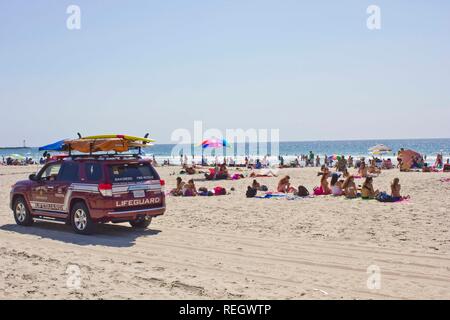 SAN DIEGO, USA - AUGUST 22 2013: Lifeguard vehicle on Mission Bay Beach with people in San Diego, California Stock Photo