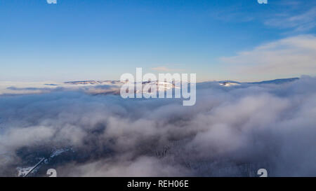 Aerial landscape - Lago-Naki, clouds under mountains Stock Photo