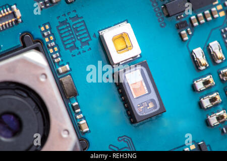 Heart rate sensor on a mobile phone main board next to led diode Stock Photo