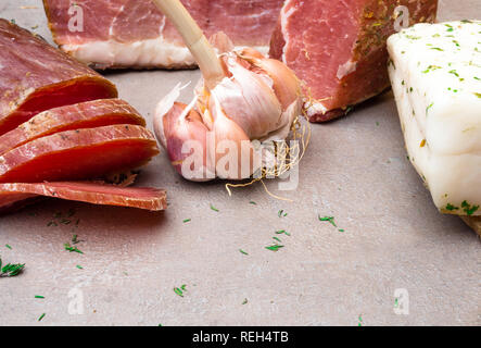 Antipasti and catering platter with different mix of meat, spices thyme, garlic on grey stone background Stock Photo