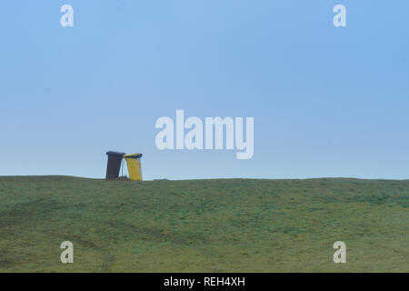 grass with azun sky and two garbage cans Stock Photo