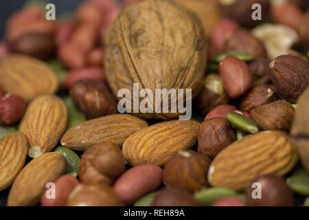 Variety of organic healthy nuts including almonds, hazelnuts spread on the table Stock Photo