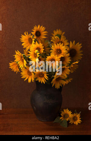 Still life. Beautiful Sunflowers in old clay pot. Stock Photo