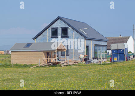 House under construction. In the style and proportions of traditional Hebridean Islands, West Coast, Scotland. Isle of Iona, Inner Hebrides. Note Insulation wall cladding panels in place.​ Stock Photo