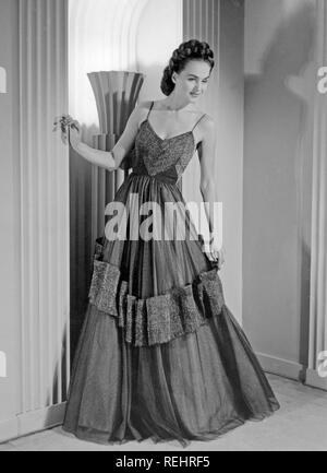 Women's fashion in the 1940s. A young woman in a typical 1940s outfit, a long evening dress. Her name is Hjördig Genberg and is the wife of British actor David Niven. Photo Kristoffersson. Sweden 1946 Stock Photo