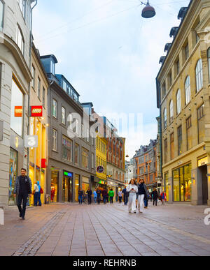 COPENHAGEN, DENMARK - JUNE 16, 2018: People walk by the Stroget street - the main shopping street of Copenhagen.