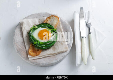 Green beans with sunny side fried egg on toast Stock Photo