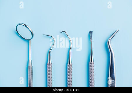 Dental instruments. Dentists tools on blue background. Stock Photo