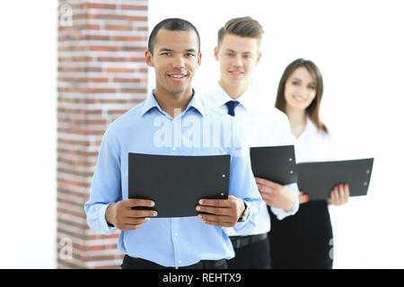 successful business team holding folders with documents standing in the office Stock Photo